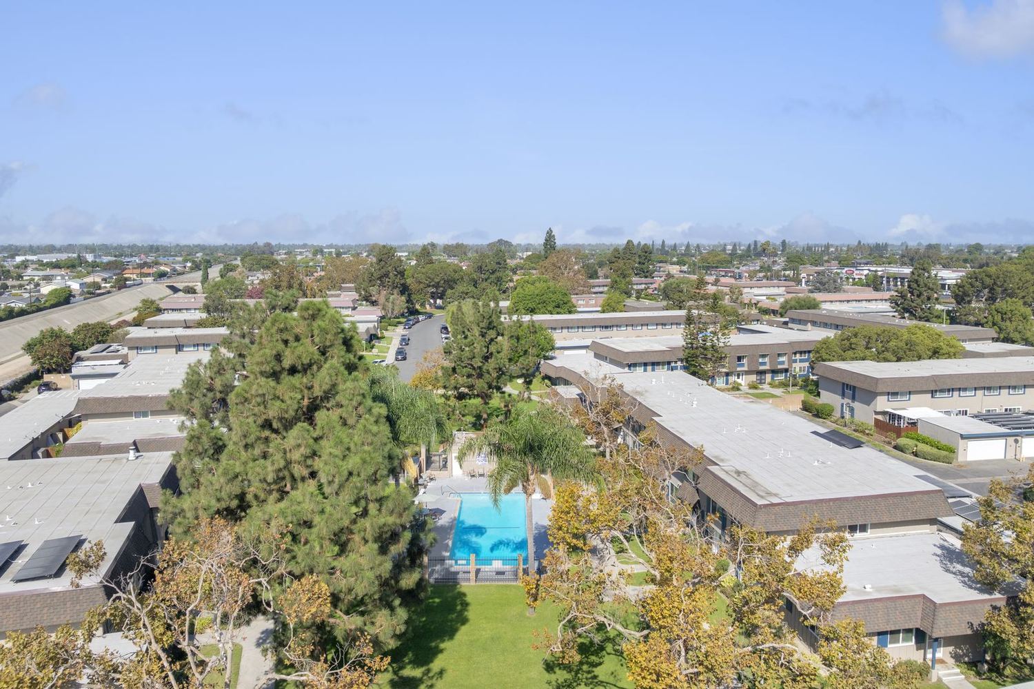 Rows of Tanglewood townhomes with shake mansard roofs seen from above