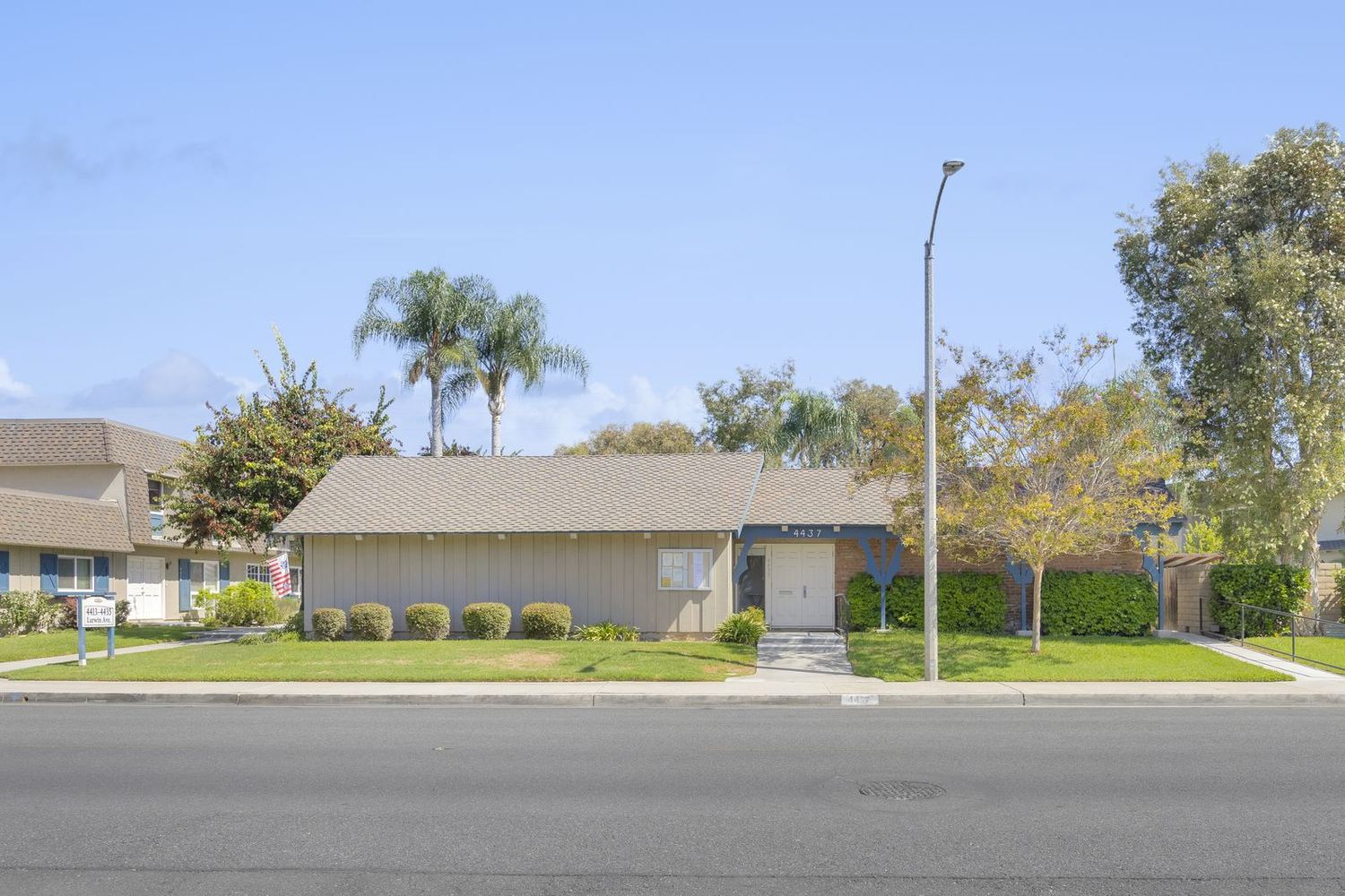 The Clubhouse and lawn seen from Larwin Avenue on a clear morning
